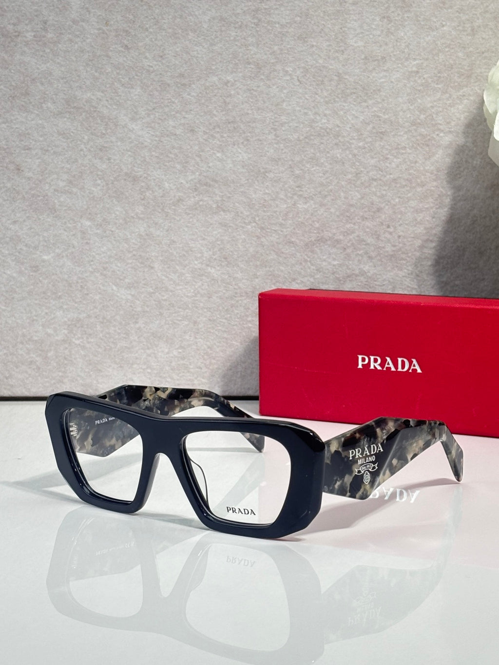 Prada black rectangular eyeglasses with clear lenses and tortoise-accent temples