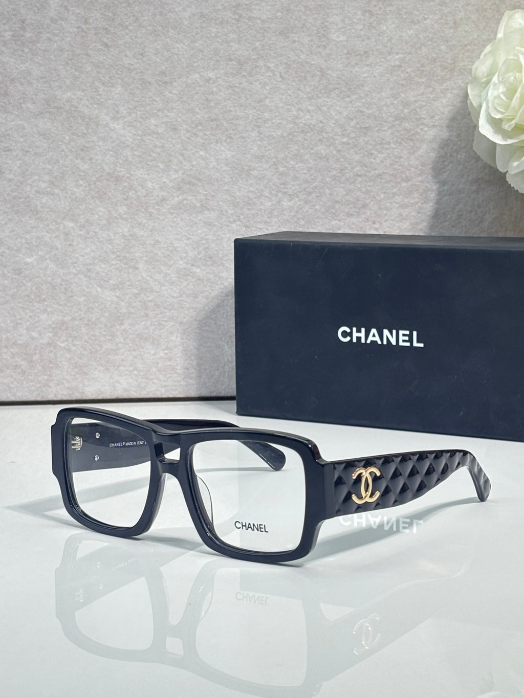 Dark navy rectangular eyeglasses with CHANEL logo and patterned temple arms