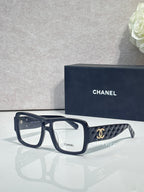 Dark navy rectangular eyeglasses with CHANEL logo and patterned temple arms