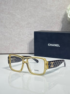 Gold rectangular eyeglasses with CHANEL logo and patterned temple arms