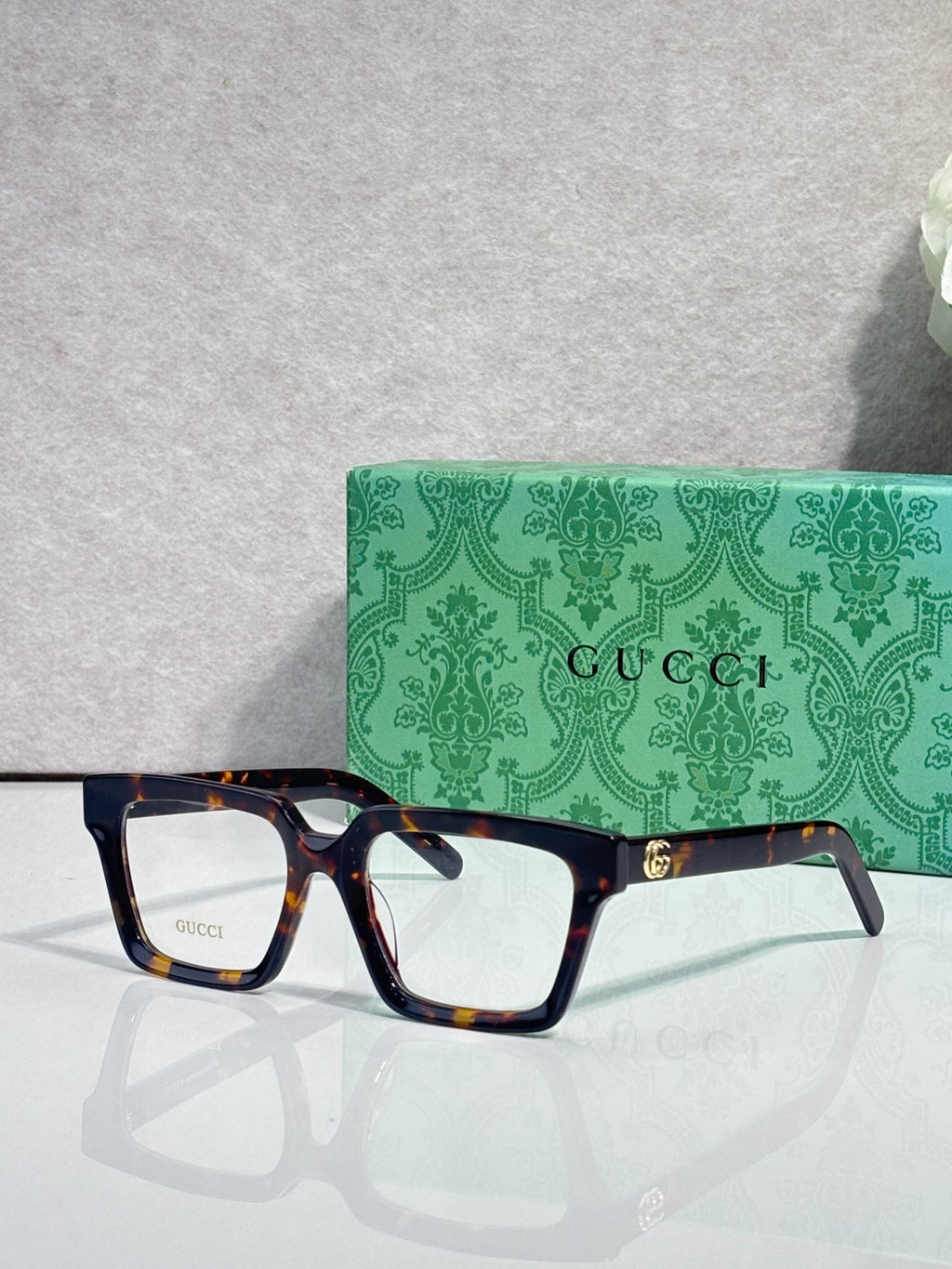 Gucci tortoiseshell rectangular eyeglasses with clear lenses and gold bridge logo