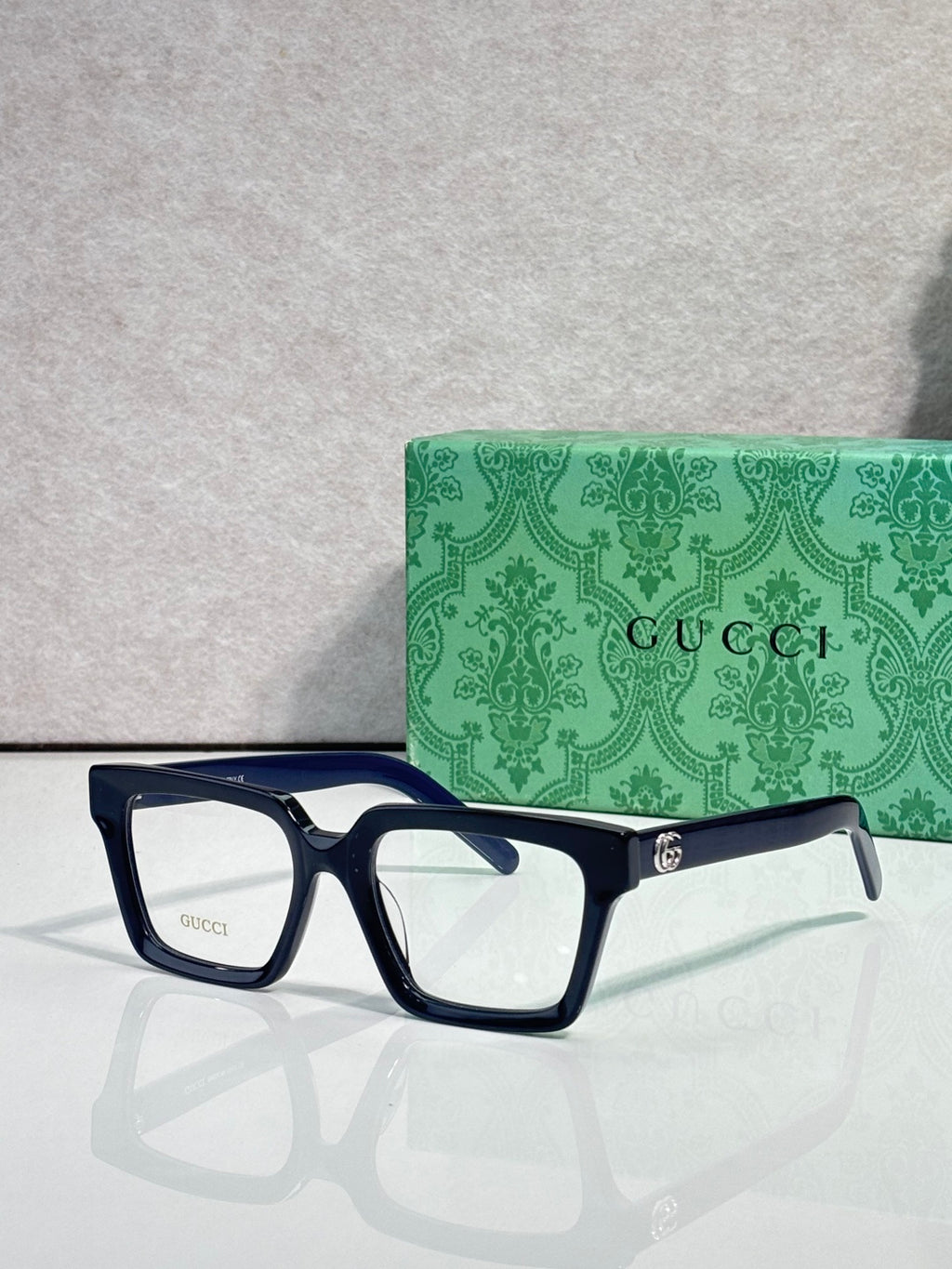 Gucci blue rectangular eyeglasses with clear lenses and gold logo detail