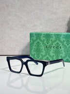Gucci blue rectangular eyeglasses with clear lenses and gold logo detail