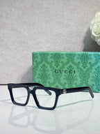 Gucci dark blue rectangular eyeglasses with clear lenses and gold bridge hardware