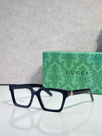 Gucci dark blue rectangular eyeglasses with clear lenses and gold hinge detail