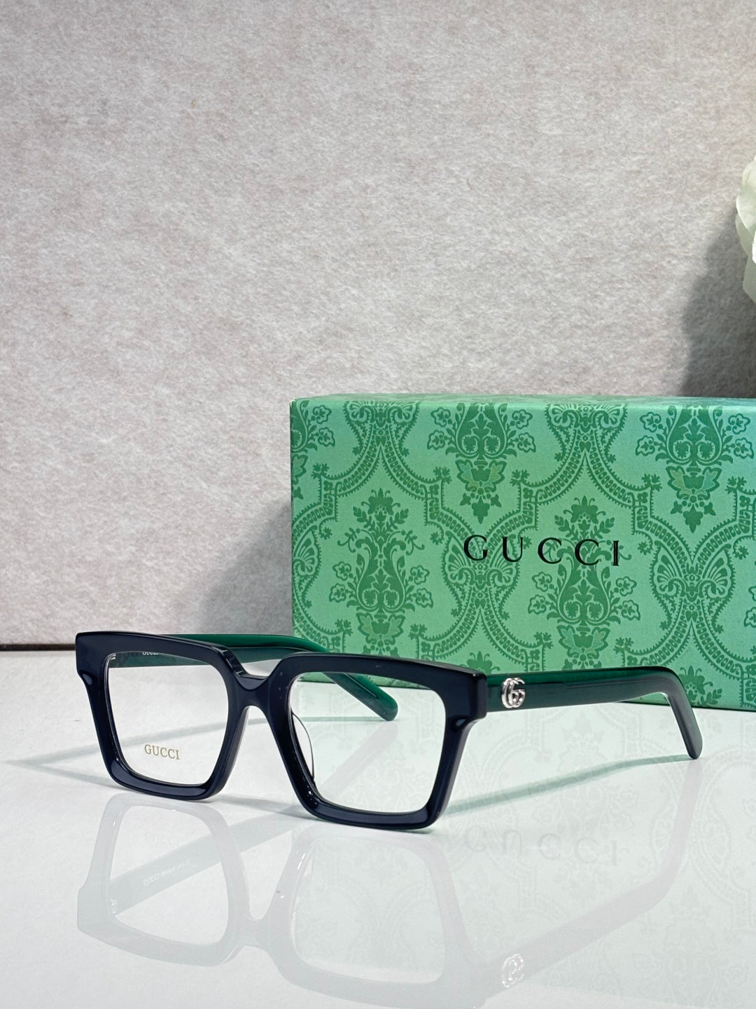 Gucci dark blue rectangular eyeglasses with clear lenses and gold logo detail
