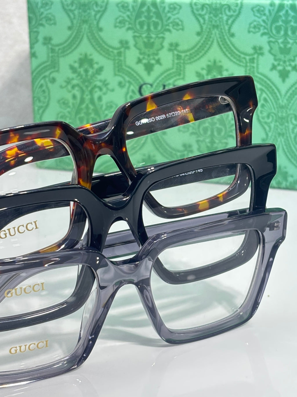 Gucci tortoiseshell rectangular eyeglasses with clear lenses and Gucci branding