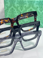 Gucci tortoiseshell rectangular eyeglasses with clear lenses and Gucci branding