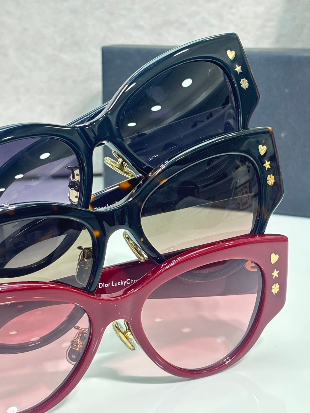 Sunglasses set: dark blue and red frames with gold motifs and tinted lenses