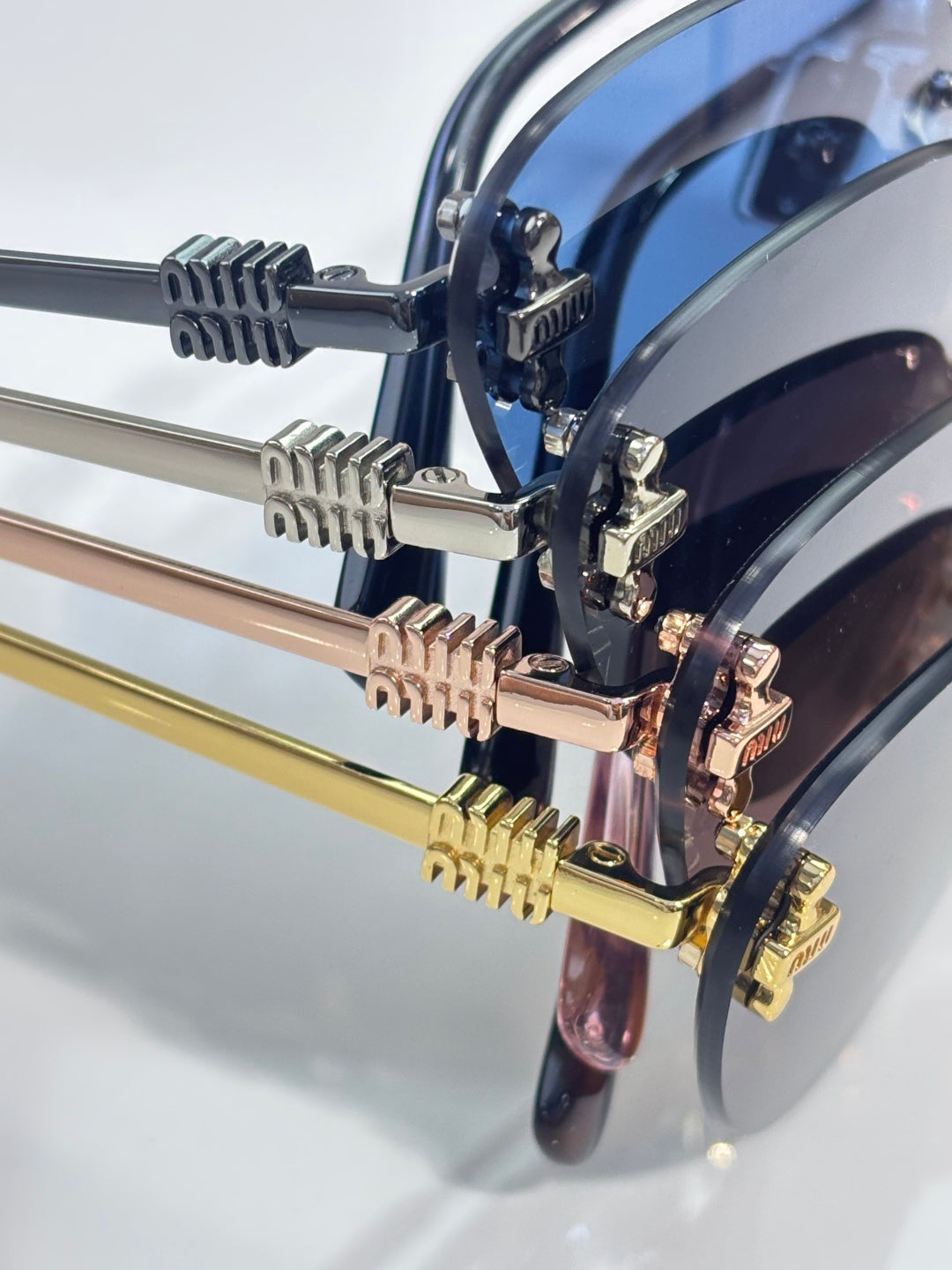 Sunglasses frame hardware close-up with metal hinges and logo details