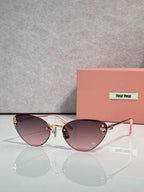 Sunglasses with gold round frames and mauve tinted lenses