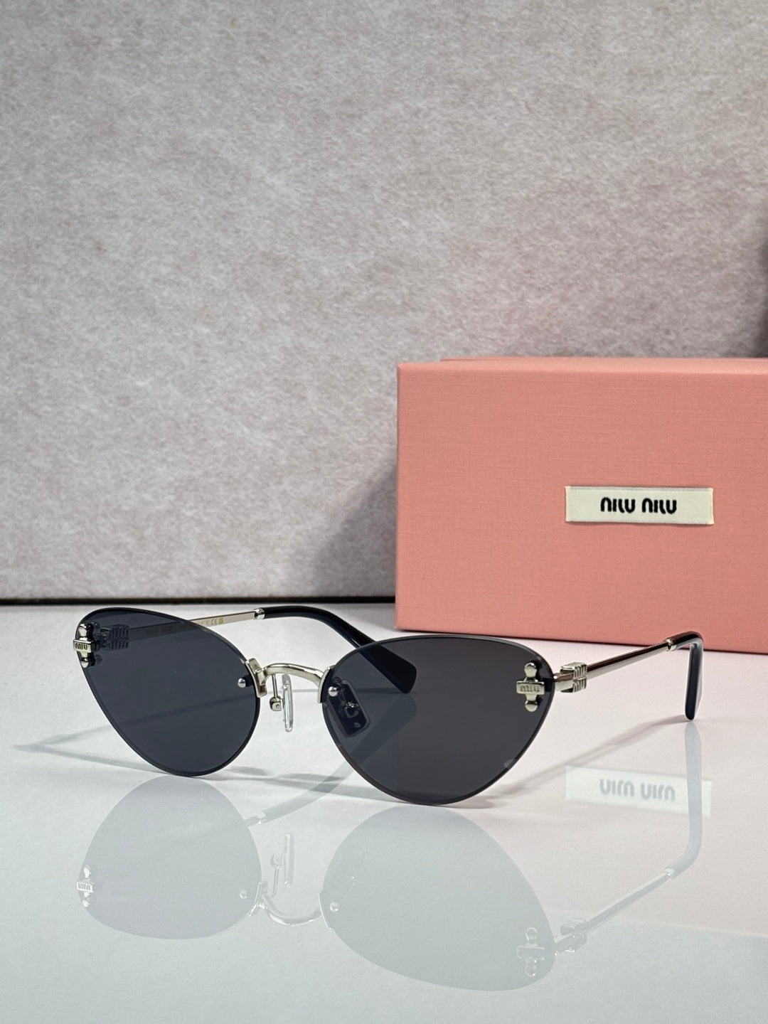 Sunglasses with black round frames and dark tinted lenses