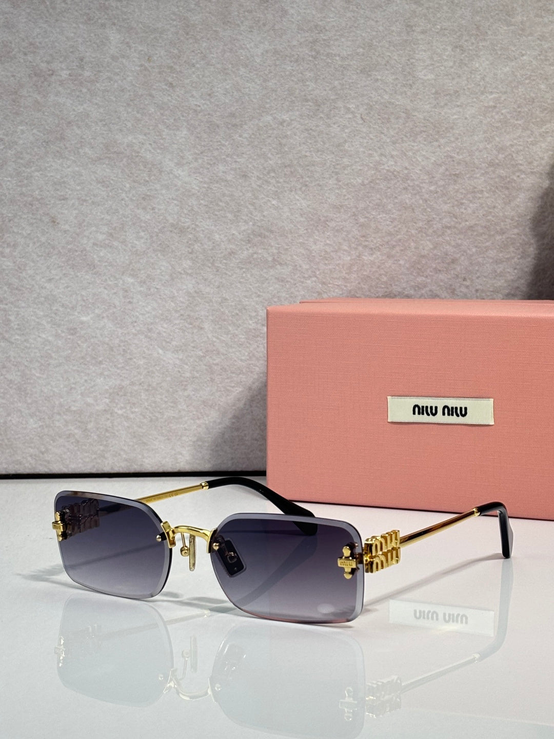 Sunglasses with dark blue lenses and gold metal frame, slim black arms