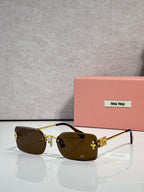 Sunglasses with amber-brown lenses, gold frame, maroon detail on arms