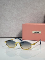 Gold-tone sunglasses with light blue lenses and black arms, rectangular cat-eye style.