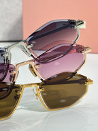 Close-up of stacked sunglasses frames with purple lenses and gold-tone hardware.