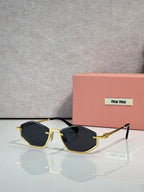 Gold-tone sunglasses with dark blue lenses and black arms, rectangular cat-eye style.