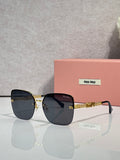 Sunglasses with dark blue lenses, gold frame and chain temples, black ear tips.