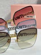 Sunglasses close-up: stacked gold-and-black temple lettering and pink lenses.