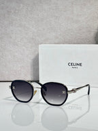 Round sunglasses with dark blue frame and dark lenses, gold-tone hinges and bridge