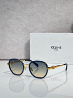 Round sunglasses with navy frame and gold-tone rims, light gradient lenses