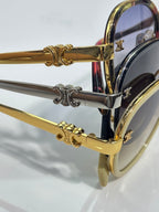 Close-up of gold and silver sunglass temple arms with decorative hardware