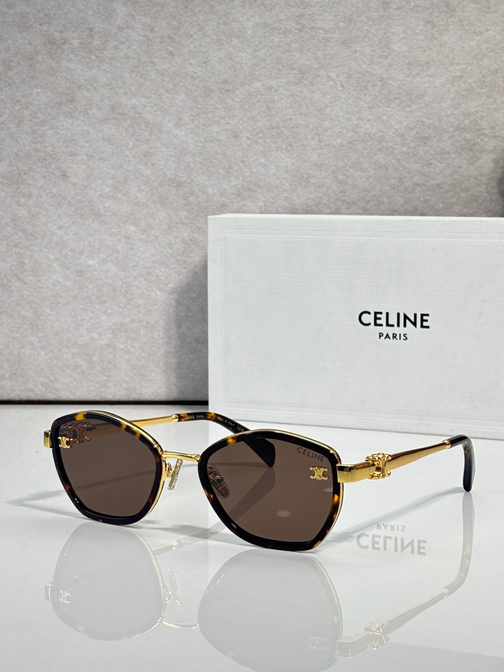 Celine sunglasses with round gold frames and dark tinted lenses