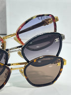 Celine sunglasses close-up with dark round lenses and gold-tone temple details