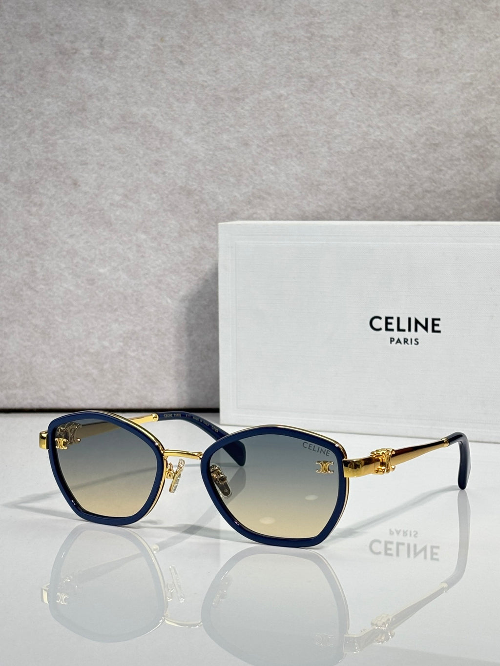Celine sunglasses with round blue frames and tinted lenses, gold-tone accents