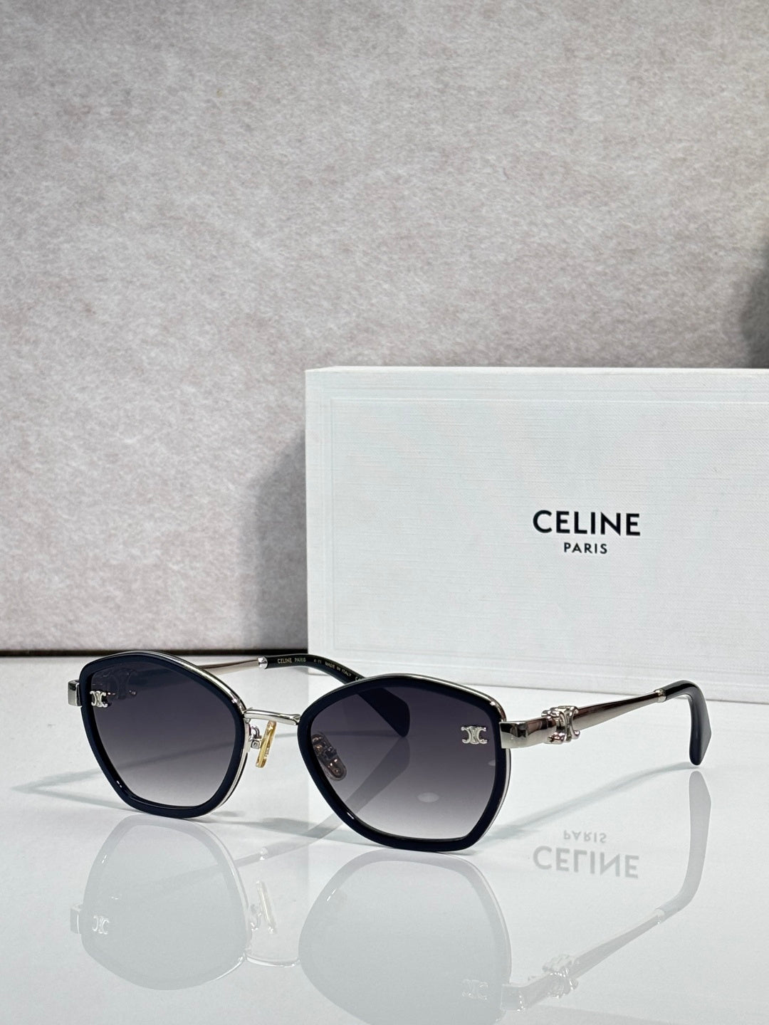 Celine sunglasses with round dark frames and tinted lenses, gold-tone details