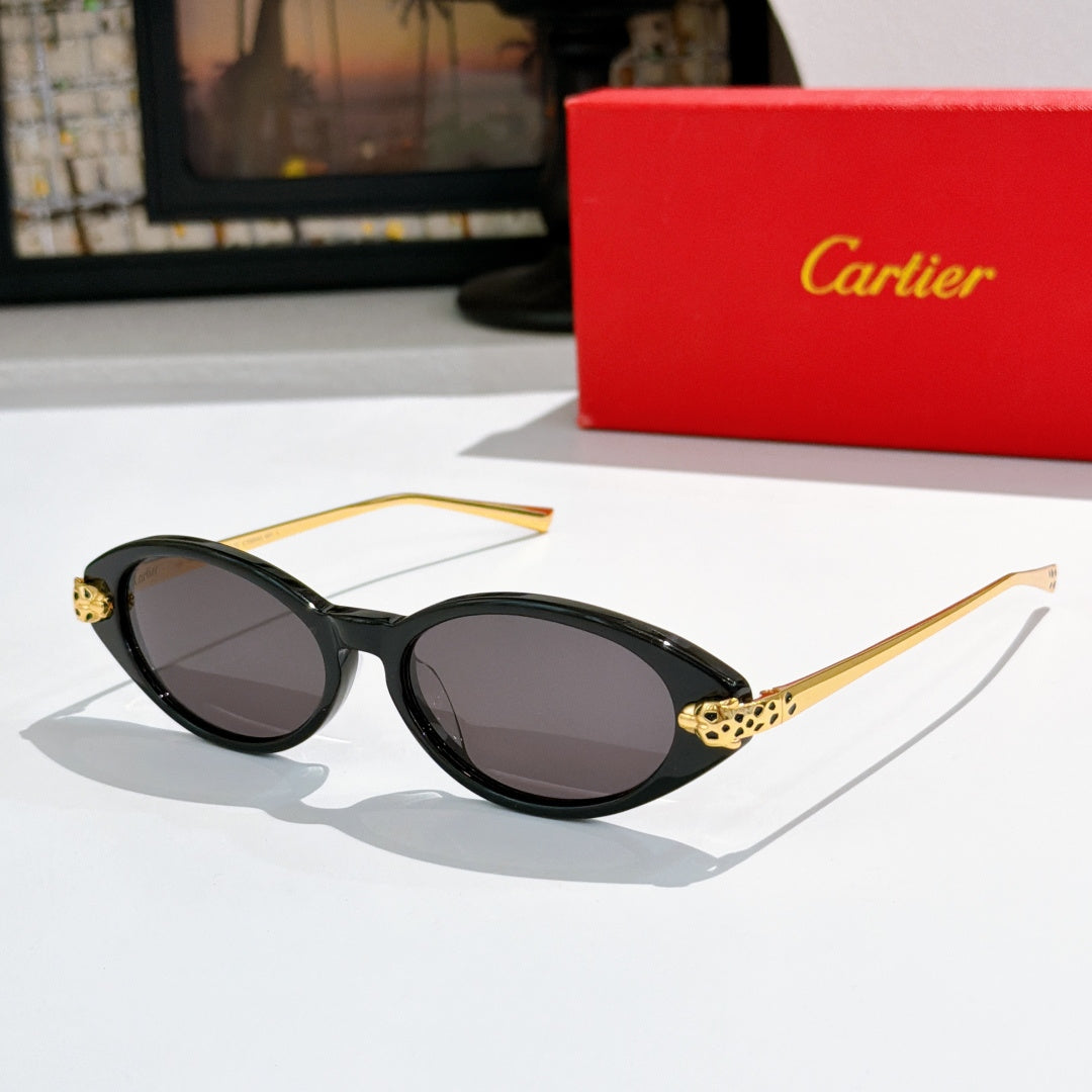 Black oval sunglasses with dark lenses and gold-tone leopard temple detail