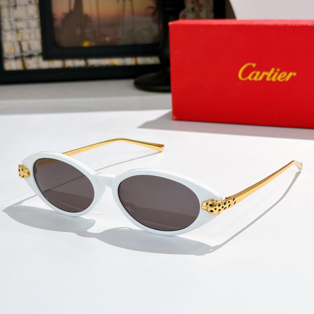 White oval sunglasses with dark lenses and gold-tone leopard temple detail