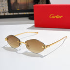 Gold-tone round sunglasses with amber lenses and patterned temple accents