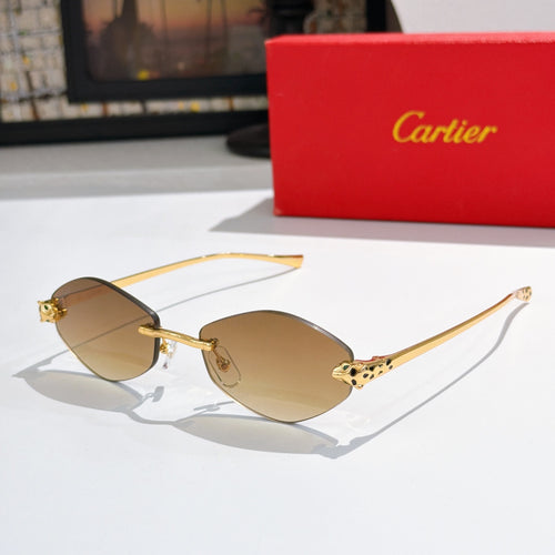Gold-tone round sunglasses with amber lenses and patterned temple accents