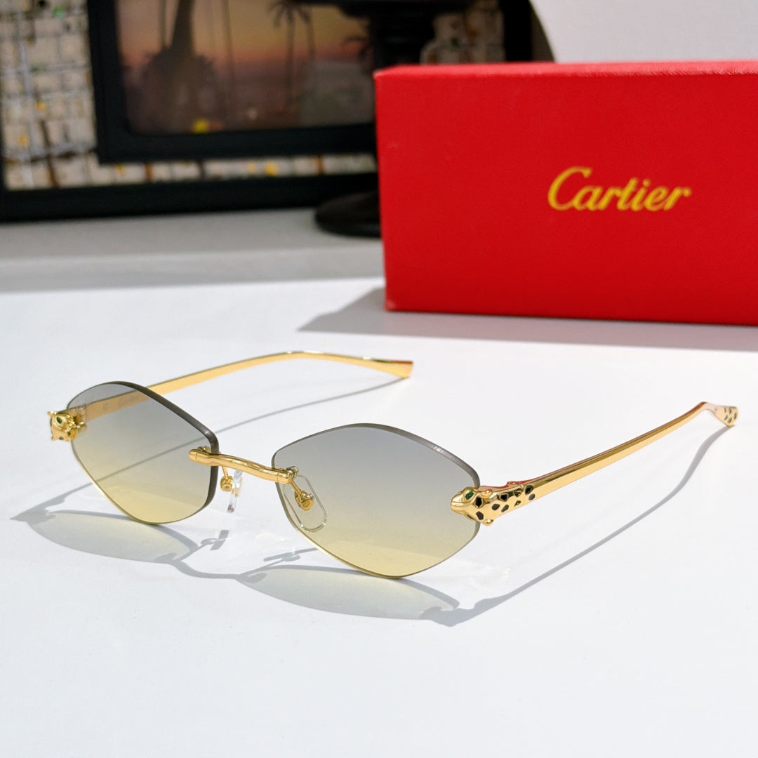 Gold-tone round sunglasses with warm amber lenses and patterned temple accents