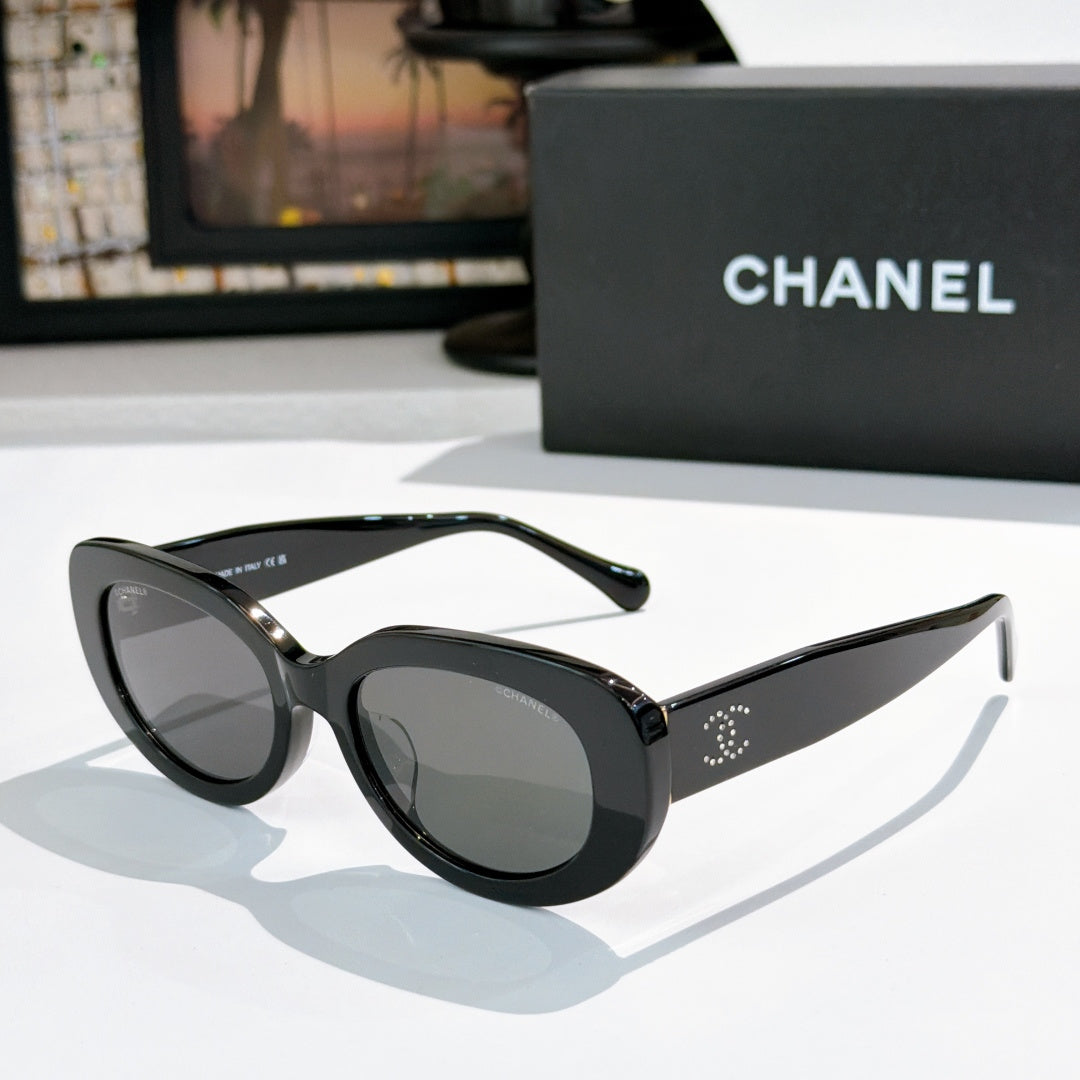 Chanel sunglasses, black frame with gray tinted lenses and stud detail on arms