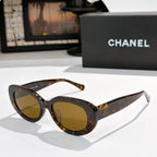 Chanel sunglasses, tortoiseshell frame with amber tinted lenses and curved arms