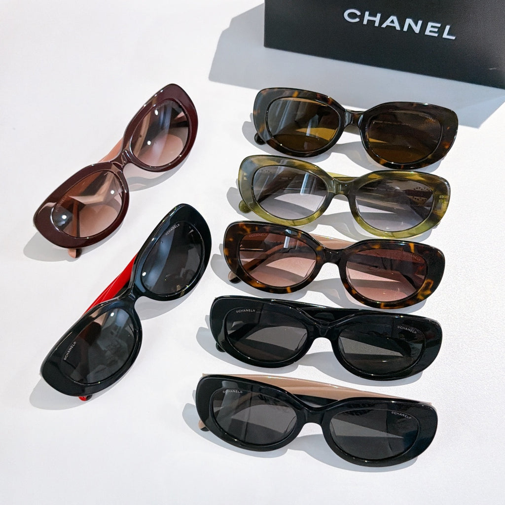 Assorted Chanel sunglasses, mixed frames in black, brown, green, and red with tinted lenses