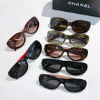 Assorted Chanel sunglasses, mixed frames in black, brown, green, and red with tinted lenses