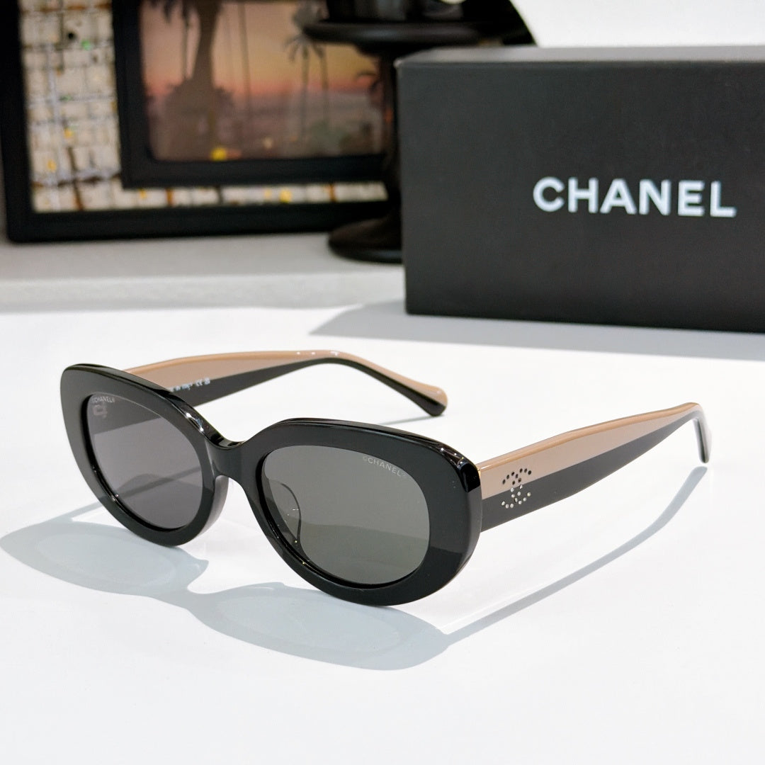 Chanel sunglasses, black frame with tan temples and dark tinted lenses