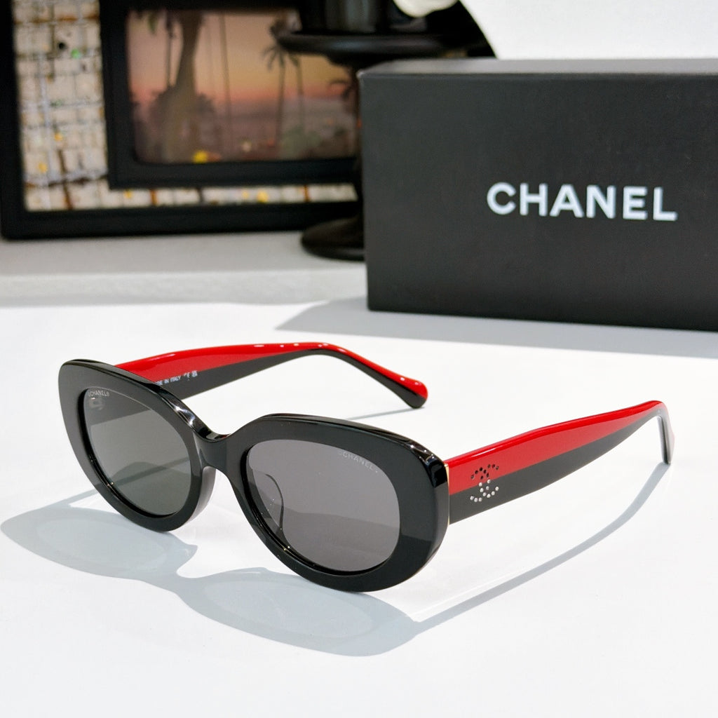 Chanel sunglasses, black frame with red temples and dark tinted lenses