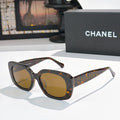Tortoise square sunglasses with amber tinted lenses, logo on side temples
