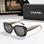 Black square sunglasses with dark gray tinted lenses, logo on side temples