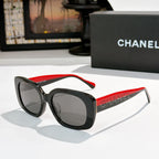 Black square sunglasses with gray tinted lenses, red side temples with logo