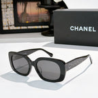 Black square sunglasses with gray tinted lenses, logo on side temples