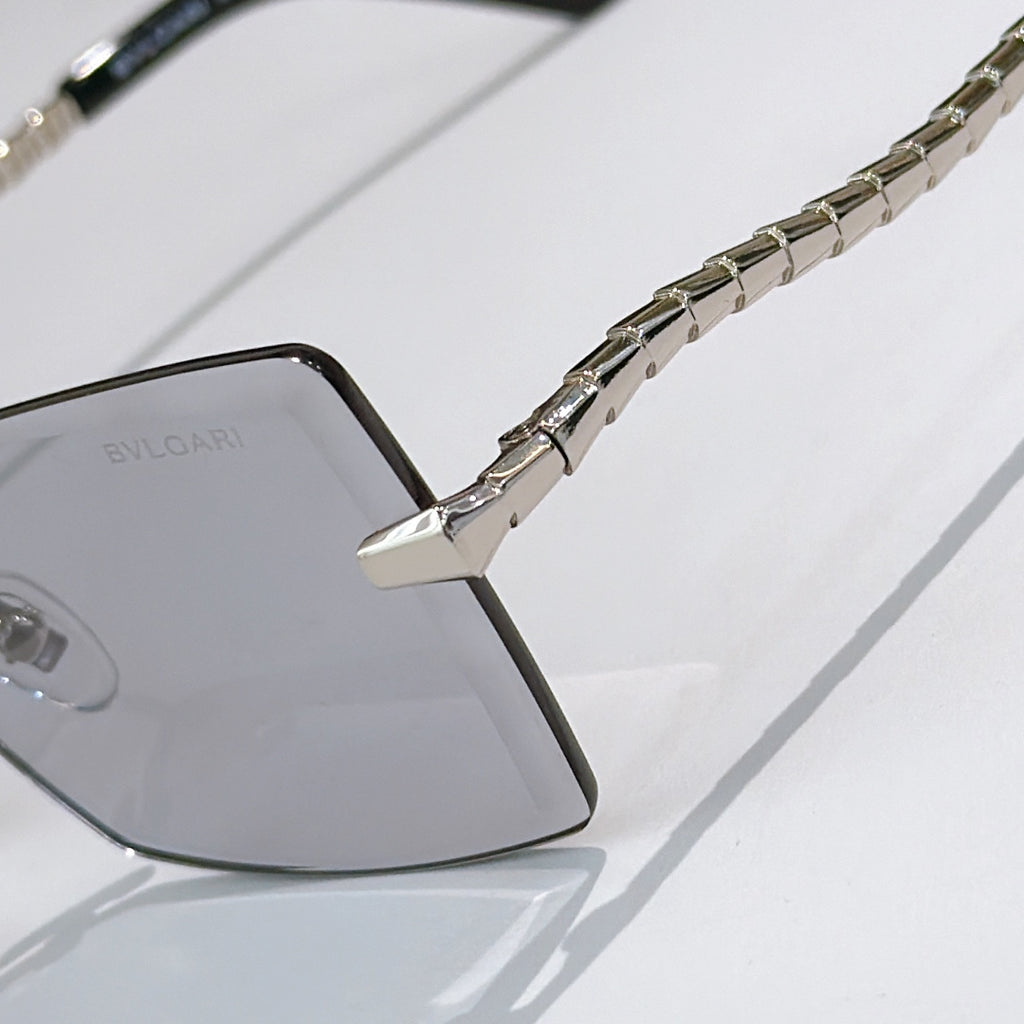 Bvlgari square sunglasses close-up with dark temple arm and chain detail