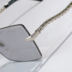 Bvlgari square sunglasses close-up with dark temple arm and chain detail