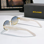 Sunglasses side view with blue lenses and clear temples, gold-tone accents