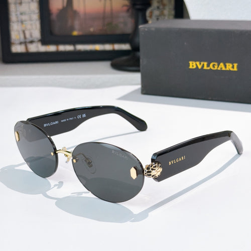 Sunglasses with dark lenses and gold-tone frame, round-oval style