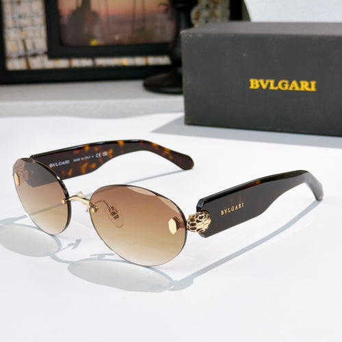 Sunglasses with tortoiseshell arms, amber-brown lenses, gold-tone frame